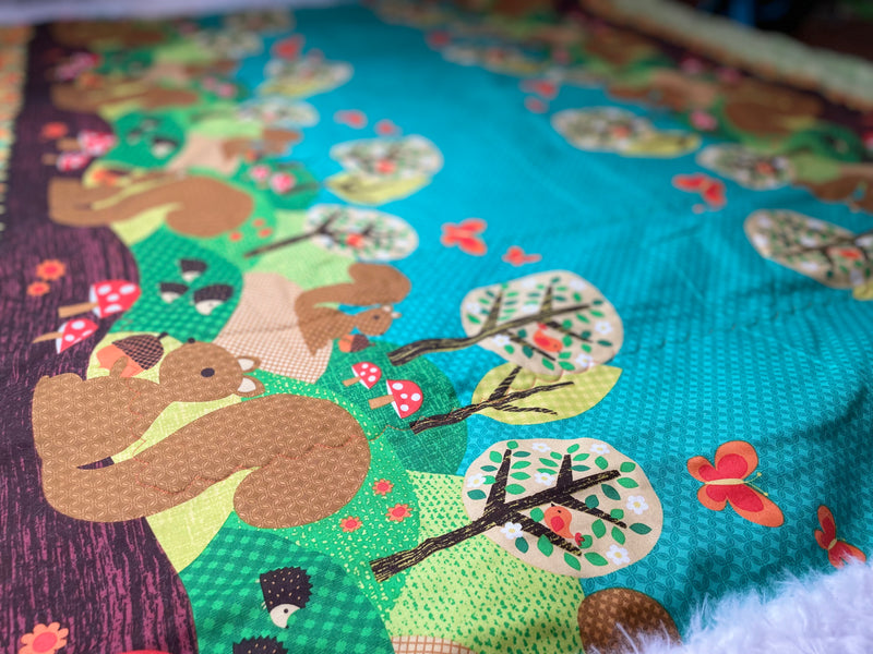 Squirrels in the Garden Quilted Blanket